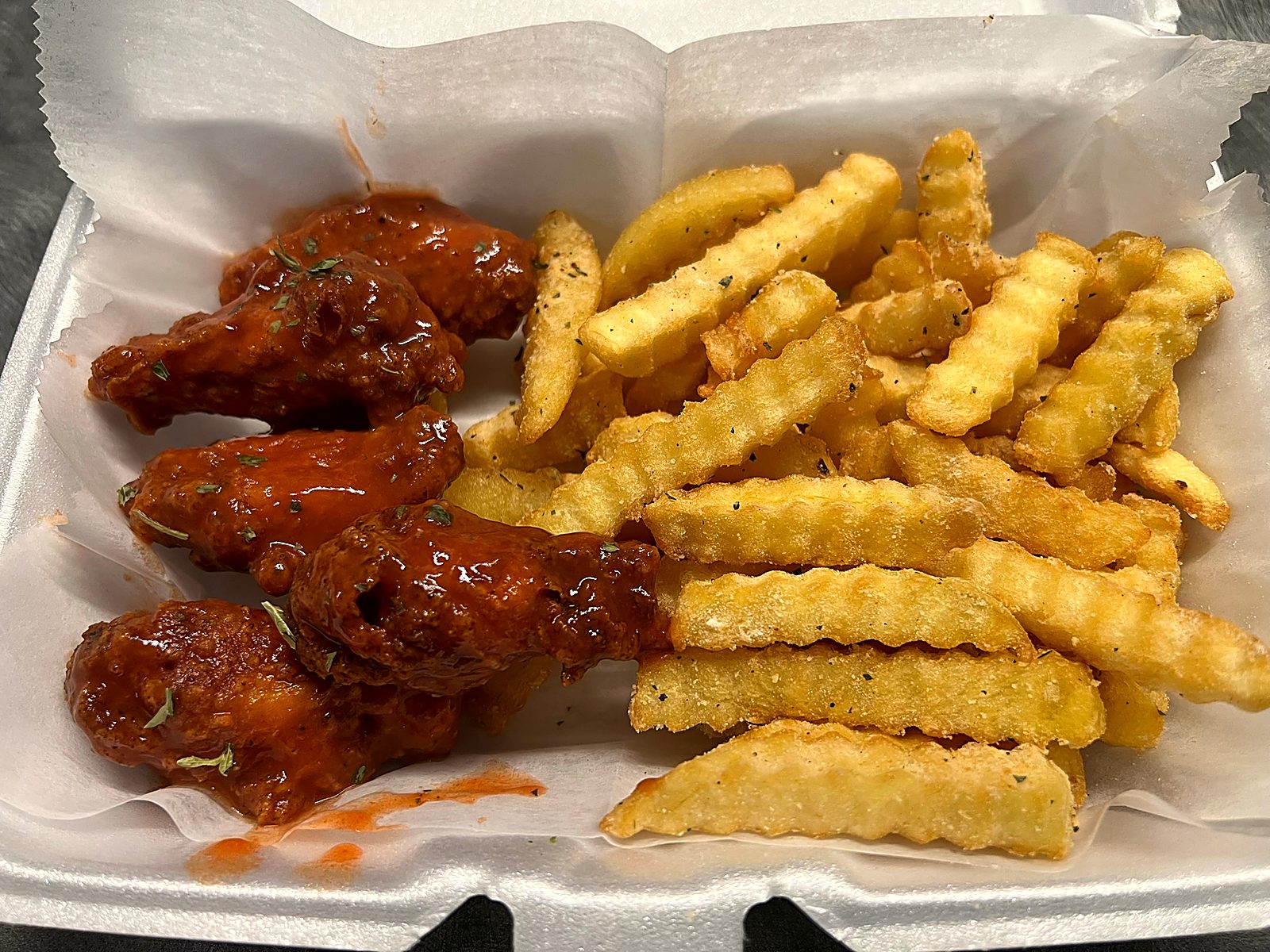 Buffalo wings and seasoned crinkle fries
